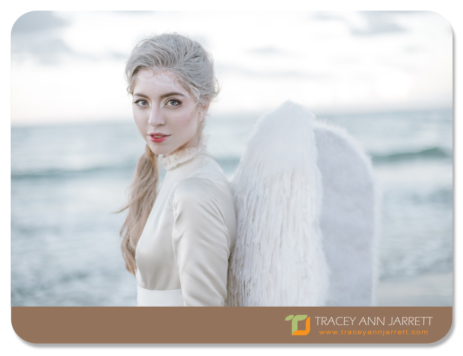 angel themed shoot of model on the beach